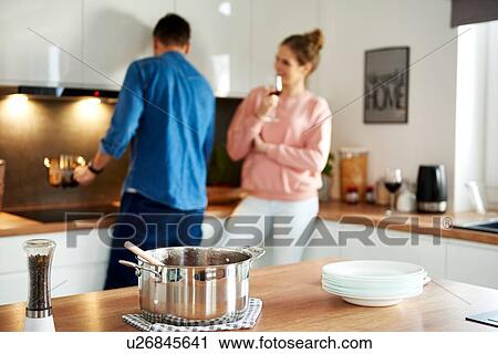 Couple talking in kitchen View Large Photo Image Stock Image - Couple talking in kitchen. Fotosearch