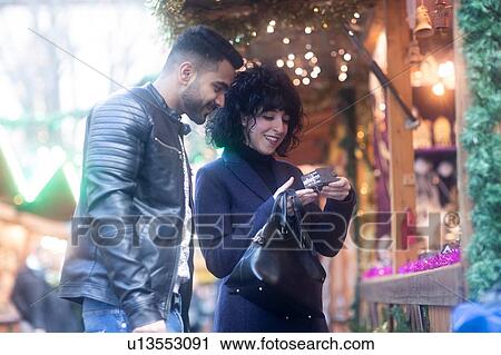 Couple window shopping at Christmas market, Freiburg, Baden-Wurttemberg, Germany View Large Photo Image Stock Image - Couple window shopping at Christmas market, Freiburg, Baden-Wurttemberg, Germany. Fotosearch