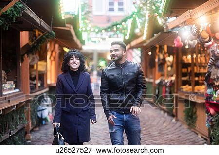 Stock Photo - Couple window shopping at Christmas market, Freiburg, Baden-Wurttemberg, Germany. Fotosearch
