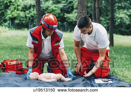 Stock Image - CPR training on baby dummy. Fotosearch