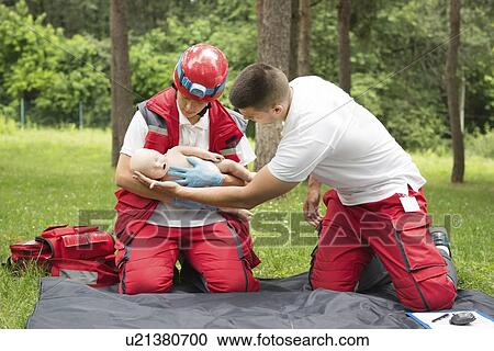 Stock Image - CPR training on baby dummy. Fotosearch