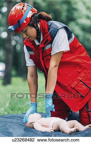 Stock Image - CPR training on baby dummy. Fotosearch