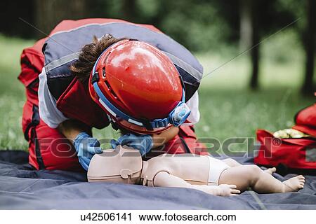 Stock Image - CPR training on baby dummy. Fotosearch