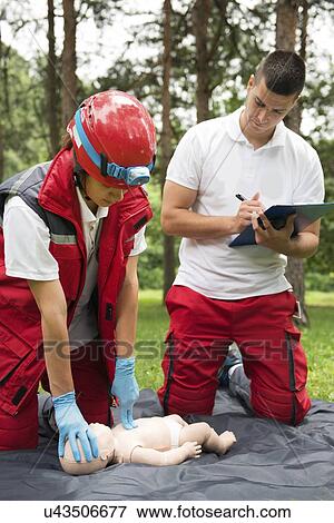 Stock Photo - CPR training on baby dummy. Fotosearch