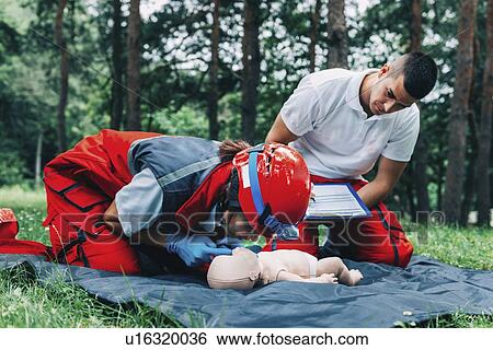 Stock Photograph - CPR training on baby dummy. Fotosearch