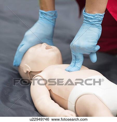 CPR training on baby dummy View Large Photo Image Stock Photograph - CPR training on baby dummy. Fotosearch