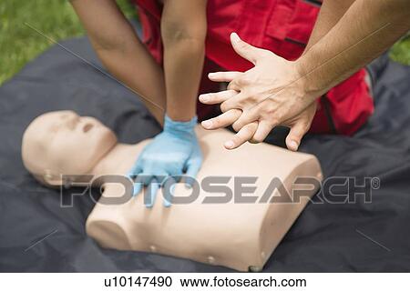 Stock Image - CPR training on dummy. Fotosearch