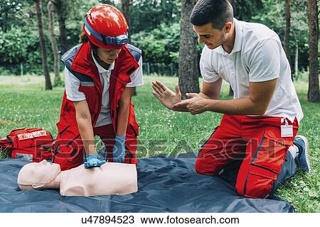 Stock Image - CPR training on dummy. Fotosearch