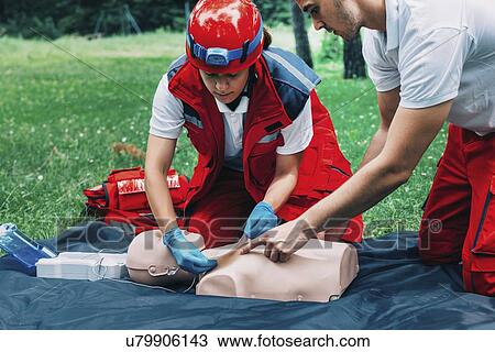 Stock Image - CPR training on dummy. Fotosearch