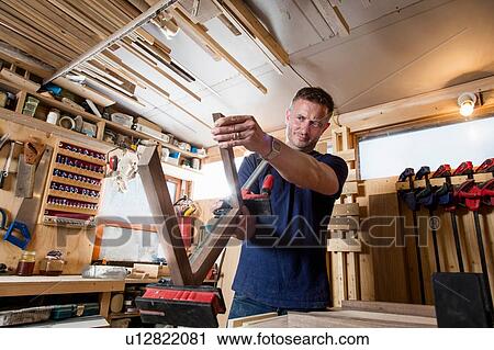 Craftsman preparing parts for wooden object View Large Photo Image Stock Image - Craftsman preparing parts for wooden object. Fotosearch