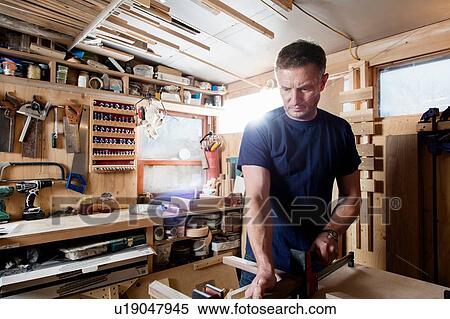 Craftsman preparing parts for wooden object View Large Photo Image Stock Photography - Craftsman preparing parts for wooden object. Fotosearch