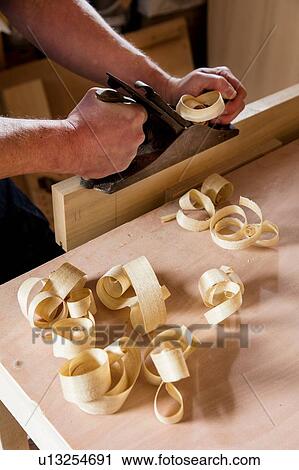 Craftsman using wood plane in workshop View Large Photo Image Stock Image - Craftsman using wood plane in workshop. Fotosearch