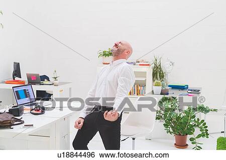 Crazy businessman playing air guitar in office View Large Photo Image Stock Photograph - Crazy businessman playing air guitar in office. Fotosearch