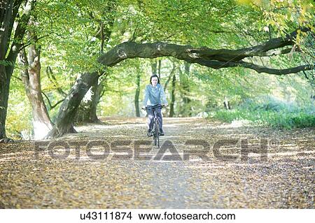 Cross country cyclist cycling in park View Large Photo Image Picture - Cross country cyclist cycling in park. Fotosearch