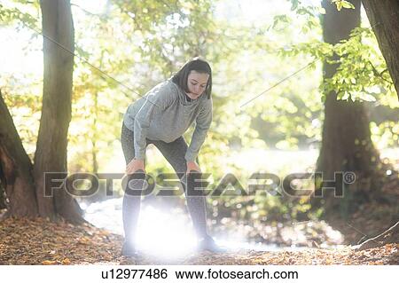 Cross country jogger resting in park View Large Photo Image Stock Photograph - Cross country jogger resting in park. Fotosearch