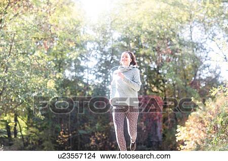 Picture - Cross country jogger running in park. Fotosearch