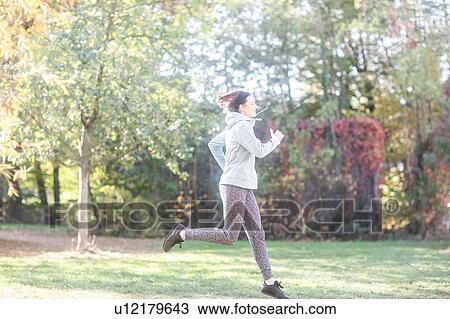 Cross country jogger running in park View Large Photo Image Stock Image - Cross country jogger running in park. Fotosearch