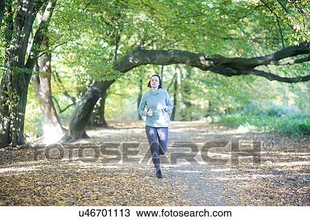 Cross country jogger running in park View Large Photo Image Stock Image - Cross country jogger running in park. Fotosearch