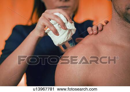 Stock Image - Cryo massage for shoulder pain. Fotosearch