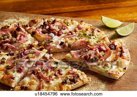 Cuban ham & swiss pizza with lime on chopping board View Large Photo Image Stock Photograph - Cuban ham & swiss pizza with lime on chopping board. Fotosearch