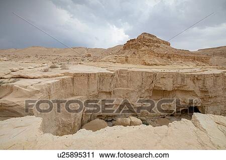 Stock Image - Deep dry river gorge cut in dry Marl sandstone by flood water, Dead Sea, Israel. Fotosearch