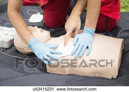 Stock Image - Defibrillator training. Fotosearch