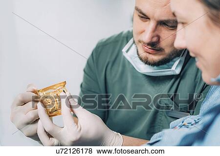 Dentist explaining dental implant procedure to patient View Large Photo Image Stock Photo - Dentist explaining dental implant procedure to patient. Fotosearch