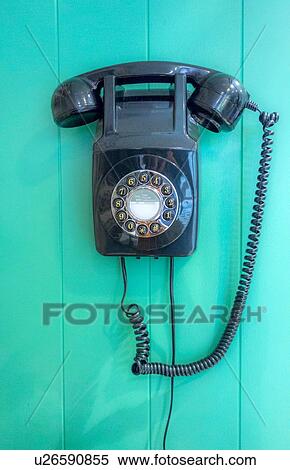 Dial phone mounted on green wall View Large Photo Image Stock Photography - Dial phone mounted on green wall. Fotosearch