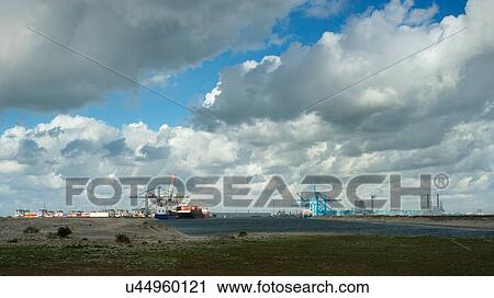 Stock Image - Distant view of container terminal situated on the newest part of Rotterdam harbour, Netherlands. Fotosearch