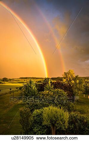 Stock Photography - Double rainbow over rural landscape, Nussbaum, Germany. Fotosearch