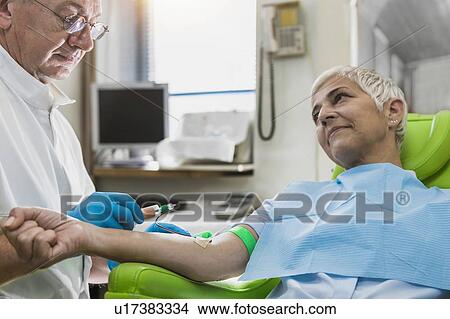 Drawing blood for platelet-rich plasma (PRP) treatment. Doctor drawing blood for a PRP cosmetics treatment. View Large Photo Image Picture - Drawing blood for platelet-rich plasma (PRP) treatment. Doctor drawing blood for a PRP cosmetics treatment.. Fotosearch