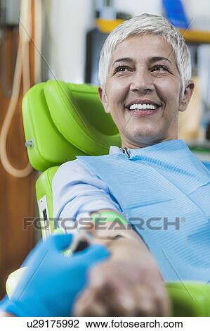 Stock Image - Drawing blood for platelet-rich plasma (PRP) treatment. Doctor drawing blood for a PRP cosmetics treatment.. Fotosearch