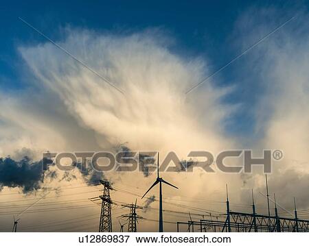 Electrical towers and wind turbines near the largest coal burning power plant in Netherlands, Eemshaven harbour View Large Photo Image Stock Photo - Electrical towers and wind turbines near the largest coal burning power plant in Netherlands, Eemshaven harbour. Fotosearch