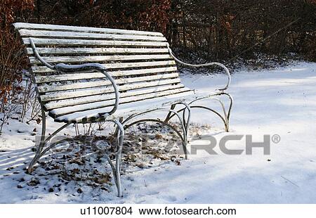 Picture - Empty bench on snowy ground. Fotosearch
