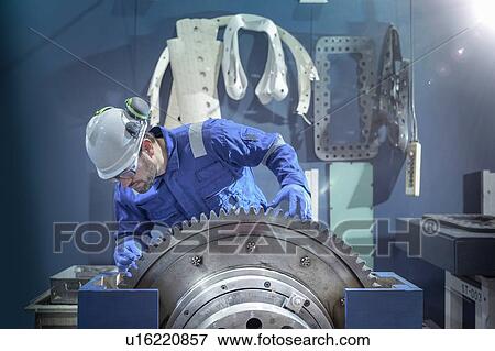 Engineer inspecting large gear during outage in nuclear power station View Large Photo Image Stock Photo - Engineer inspecting large gear during outage in nuclear power station. Fotosearch