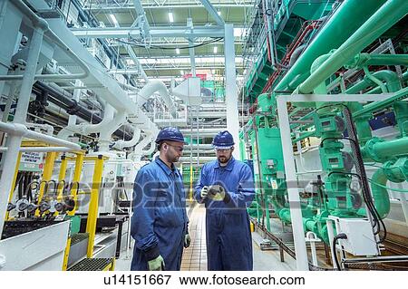 Stock Photo - Engineers in turbine hall in nuclear power station. Fotosearch