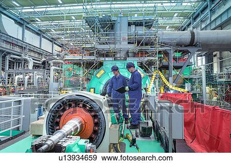Stock Photo - Engineers inspecting gears at generator end in nuclear power station during outage. Fotosearch