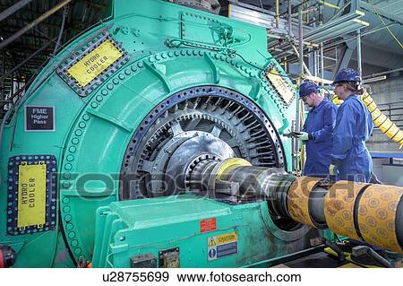 Stock Photo - Engineers inspecting generator in nuclear power station during outage. Fotosearch