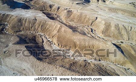 Stock Photo - Eroded sandstone mountains on sea shore, Dead Sea, Israel. Aerial photography with drone. Fotosearch