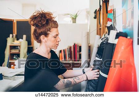 Stock Photography - Fashion designer choosing fabric. Fotosearch