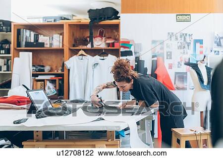 Fashion designer cutting fabric from dressmaker's pattern View Large Photo Image Stock Image - Fashion designer cutting fabric from dressmaker's pattern. Fotosearch