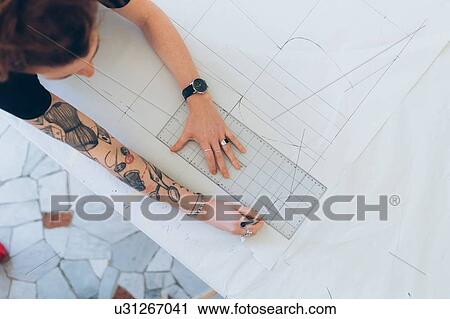 Fashion designer drawing and creating dressmaker's pattern View Large Photo Image Stock Image - Fashion designer drawing and creating dressmaker's pattern. Fotosearch