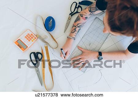 Fashion designer drawing and creating dressmaker's pattern View Large Photo Image Stock Photo - Fashion designer drawing and creating dressmaker's pattern. Fotosearch