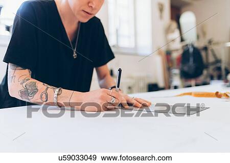 Fashion designer drawing and creating dressmaker's pattern View Large Photo Image Stock Photo - Fashion designer drawing and creating dressmaker's pattern. Fotosearch