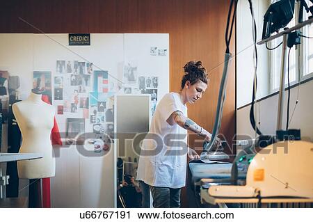 Fashion designer ironing in her work studio View Large Photo Image Stock Image - Fashion designer ironing in her work studio. Fotosearch