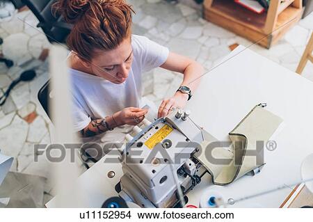 Picture - Fashion designer working at sewing machine. Fotosearch