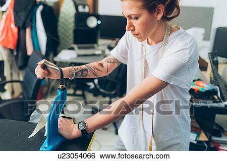 Stock Photograph - Fashion designer working in her studio. Fotosearch