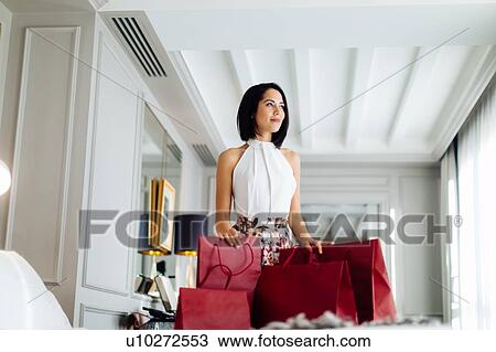 Fashionable woman with shopping bags in suite View Large Photo Image Stock Image - Fashionable woman with shopping bags in suite. Fotosearch