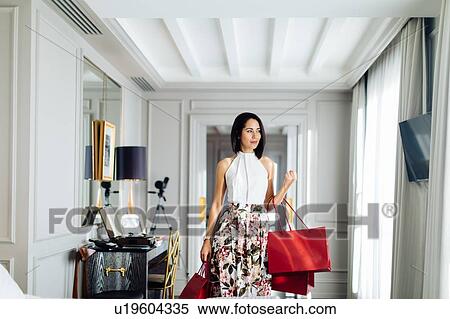 Fashionable woman with shopping bags in suite View Large Photo Image Stock Photography - Fashionable woman with shopping bags in suite. Fotosearch