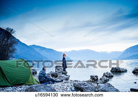 Father and son camping by lakeside, Onno, Lombardy, Italy View Large Photo Image Stock Image - Father and son camping by lakeside, Onno, Lombardy, Italy. Fotosearch